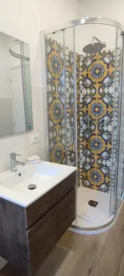 a bathroom with a shower and a white sink at San Peter Vatican City quiet and lovely apartment in Rome