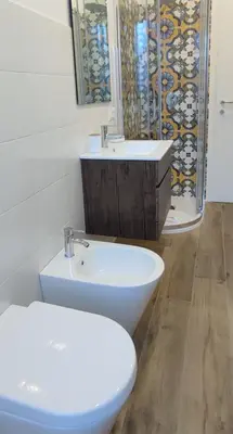 a bathroom with a toilet and a sink at San Peter Vatican City quiet and lovely apartment in Rome