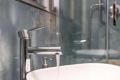 a bathroom sink with a faucet and a shower at iFlat Brand New & Modern Central Station apt in Rome