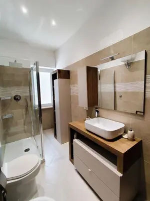 a bathroom with a sink and a toilet and a shower at La Casetta Battistini in Rome