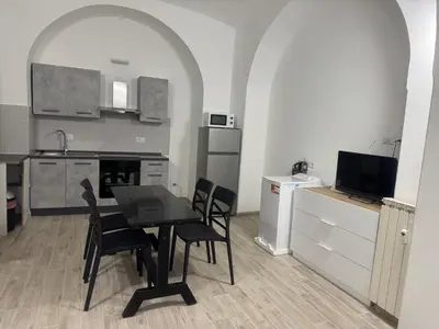 a kitchen and dining room with a table and chairs at Munsi Vatican House in Rome