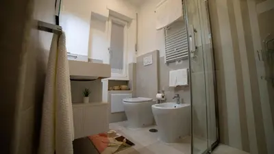 a bathroom with a toilet and a sink and a shower at Bliss House near Vatican City in Rome