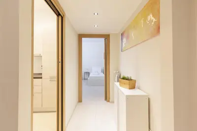 a hallway leading to a bathroom with a mirror at Hostly-The Happya Charme Suite in Rome