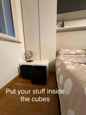 a bedroom with a bed and a nightstand next to a bed at Modern Loft Private in Rome