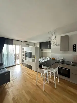 a kitchen and living room with a table and chairs at Modern Loft Private in Rome
