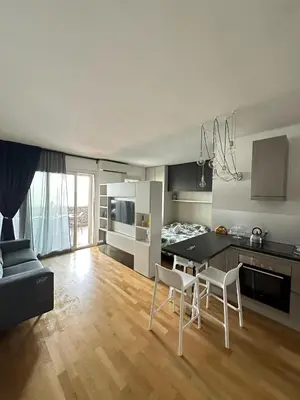 a kitchen and living room with a table and chairs at Modern Loft Private in Rome