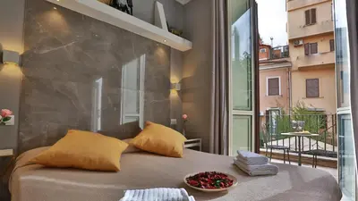a bedroom with a bed and a large window at Hotel Giolitti Smart in Rome