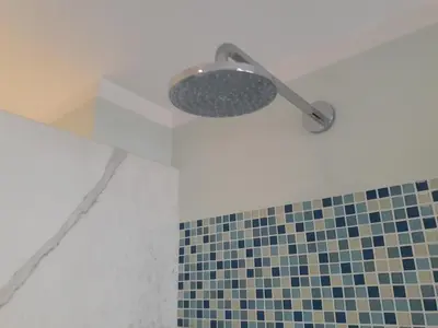 a shower in a bathroom with a tiled floor at Gallia in Rome