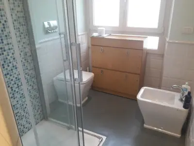 a bathroom with a shower and a toilet and a sink at Gallia in Rome