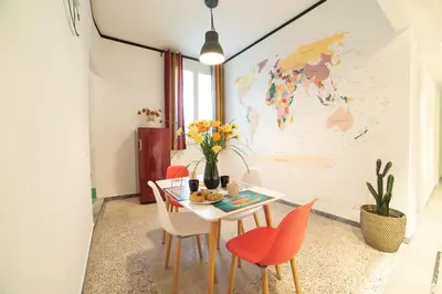 a dining room with a table and chairs with a map on the wall at The Pope's House in Rome