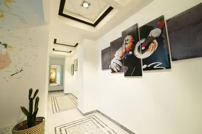 a hallway with a bunch of paintings on the wall at The Pope's House in Rome