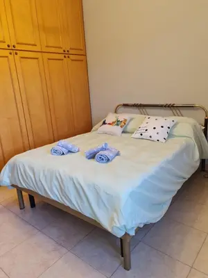 a bed with towels on it in a bedroom at La Terrazza su Roma in Rome