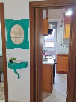 a kitchen with a table on the wall at La Terrazza su Roma in Rome