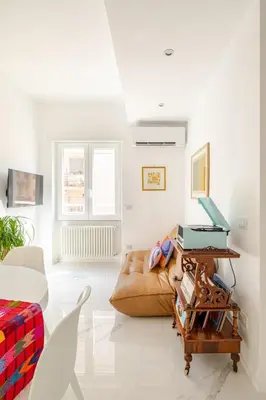 a living room with a couch and a table at Sunset House - San Paolo in Rome