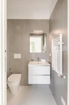 a bathroom with a white sink and a toilet at Sunset House - San Paolo in Rome