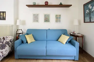 a blue couch sitting in a living room at Charming apartment in Trastevere in Rome