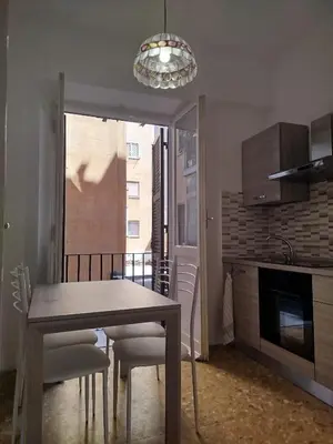 a dining room with a table and chairs in a kitchen at Sora Rosa in Rome