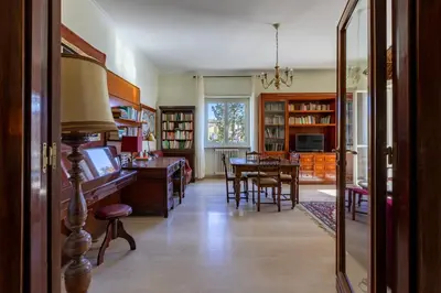 a living room with a table and a dining room at Casa di Sofia in Rome