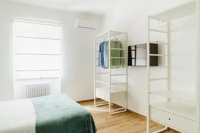 a bedroom with white shelves and a bed at Suite 155 in Rome