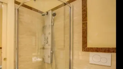 a shower with a glass door in a bathroom at Grand Master Suites in Rome