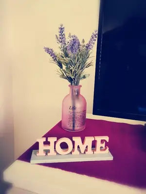 a vase with flowers in it sitting on a table at Appartamento di Nina in Rome
