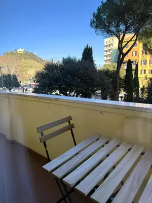 a wooden bench sitting on the side of a wall at Vatican Terrace in Rome