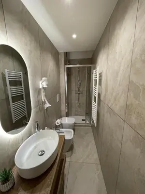 a bathroom with a sink and a toilet and a mirror at Domus Machiavelli in Rome