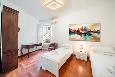 a bedroom with two beds and a desk at Apartment in Rione Ludovisi in Rome