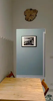 a table with two chairs and a picture on the wall at Nico's Apartment in Rome