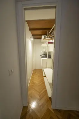 a small room with a closet with white shelves at Lovely Nest With Balcony by The Spanish Steps in Rome