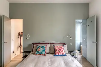 a bedroom with a large bed with two pillows at 2 bedroom apartment Flaminio Vignola in Rome