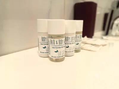 a group of four bottles of medicine sitting on a counter at Le Libellule apartment in Rome