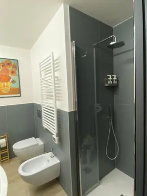 a bathroom with a toilet and a shower at Villino Ancillotto with garden and parking motorcycle space in Rome