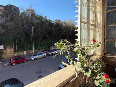 a view from a window of a street with cars parked at Apartment in the heart of EUR in Rome