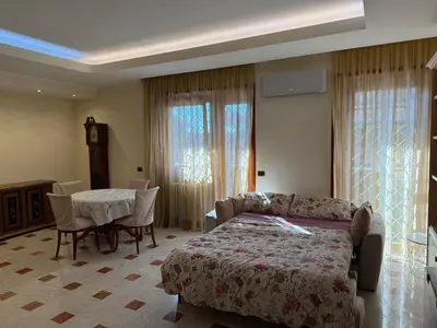 a bedroom with a bed and a table and a table and chairs at Apartment in the heart of EUR in Rome