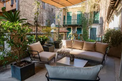 a patio with a couch and chairs and a table at Historical Palace Apartment with Large Terrace in Rome