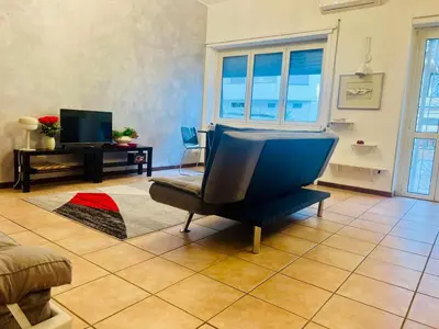 a kitchen with gray cabinets and a sink and a stove at Nansen Flats in Rome