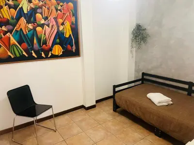 a kitchen with a red refrigerator and a couch at Nansen Flats in Rome
