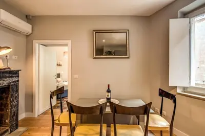 a dining room with a table and chairs at Campo di fiori 2 bedroom int 4 in Rome
