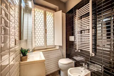a bathroom with a white toilet and a sink at Campo di fiori 2 bedroom int 4 in Rome