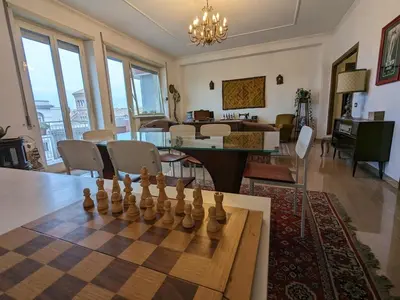 a living room with a chessboard on a table at Spacious Apartment in City Centre in Rome