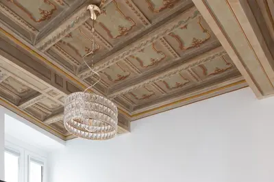 a chandelier hanging from a coffered ceiling at Modern and Bright Flat - Rome City Center in Rome