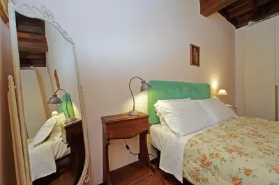 a bedroom with a bed and a mirror at Leutari in Rome