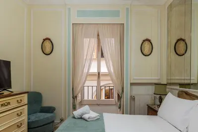 a bedroom with a bed and a door with a window at GuestHost - Piazza Navona Elegant Apartment in Rome