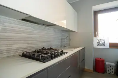 a kitchen with a stove top in a kitchen at Divine View Apartment in Rome