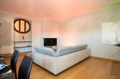 a living room with a couch and a television at Divine View Apartment in Rome