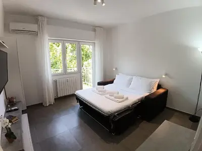 a bedroom with a bed and a large window at Gigli Felici Roma in Rome