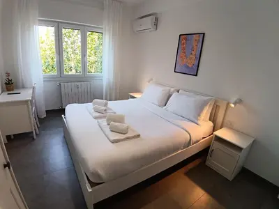 a bedroom with a large white bed with two towels on it at Gigli Felici Roma in Rome