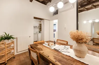 a kitchen and dining room with a wooden table at Leonina Art House in Rome