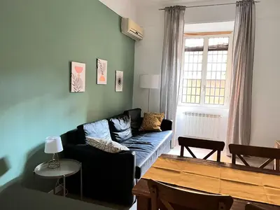 a living room with a couch and a table at La casa di Nina in Rome